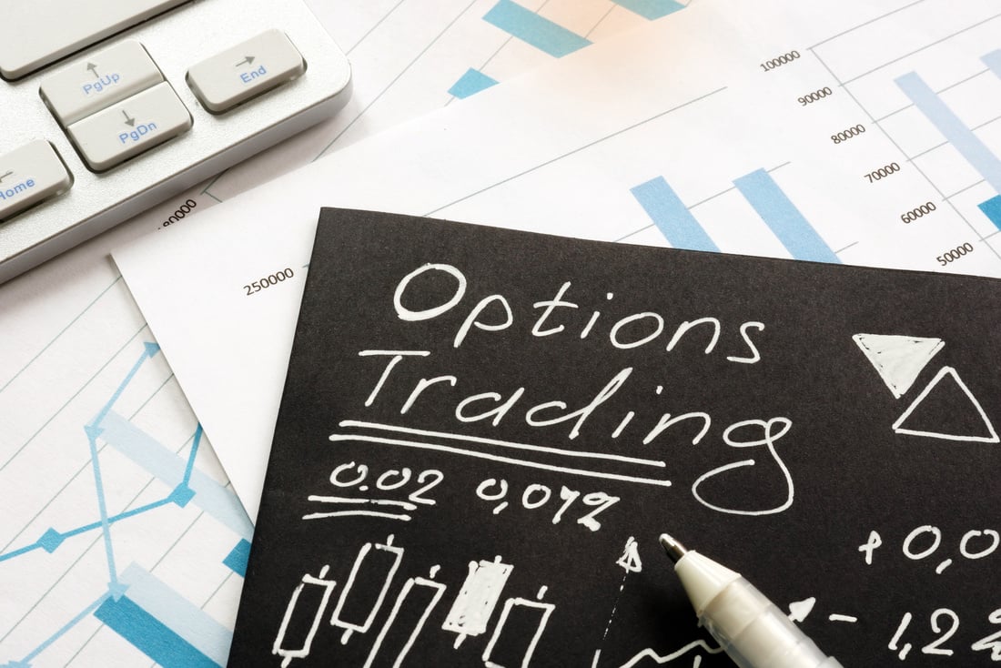 Options trading written on black piece of paper.